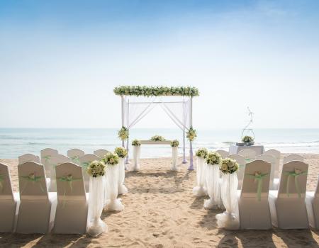 Wedding ceremony setup with chairs and altar on the beach and facing the ocean.